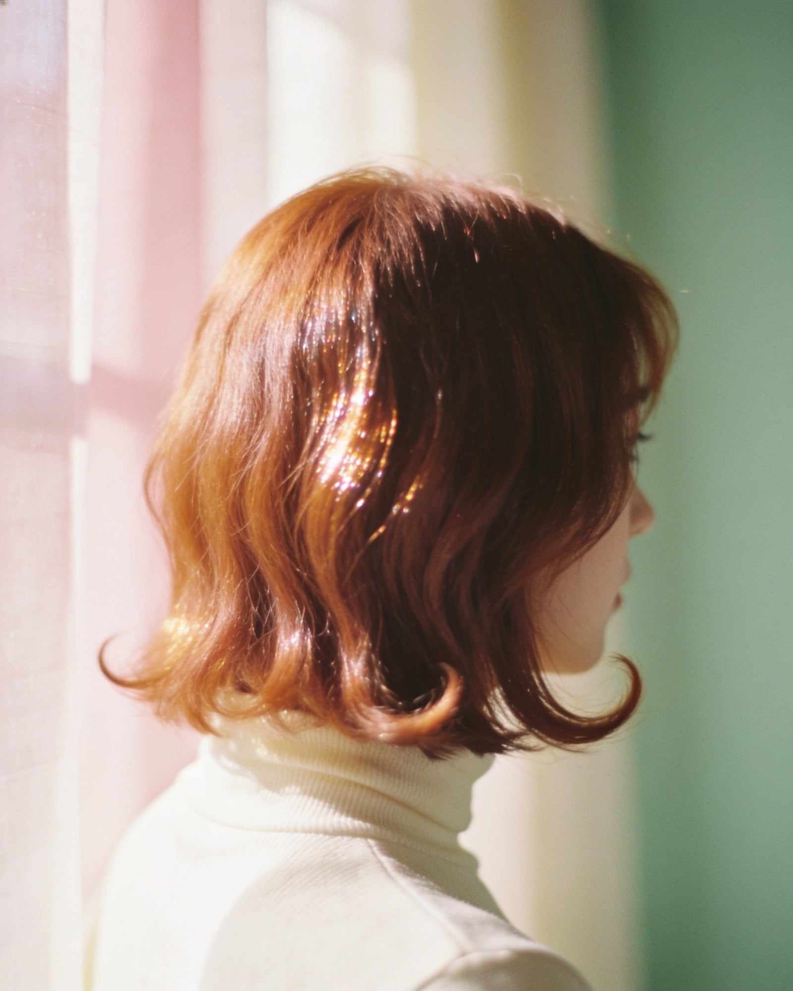 Shoulder-length hair in a rich, soft copper with a mirror-like shine.